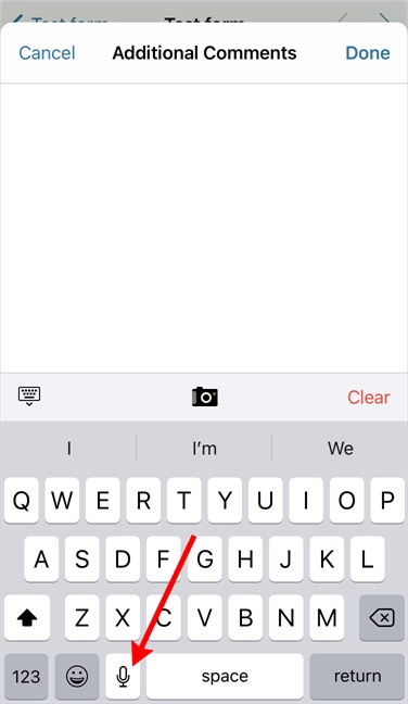 Locating the microphone feature on the iOS keyboard